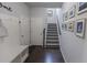 Entryway with a built-in bench, coat rack, and staircase with gray carpet at 433 Paden View Ct, Lawrenceville, GA 30044