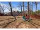 Expansive backyard with fire pit and seating area, wooden fence and view of the detached garage at 1686 Terry Mill Se Rd, Atlanta, GA 30316