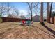 Spacious backyard with seating around a firepit and view of a detached garage and fencing at 1686 Terry Mill Se Rd, Atlanta, GA 30316