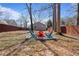 Lush backyard featuring fire pit area with Adirondack chairs, ideal for relaxing and entertaining at 1686 Terry Mill Se Rd, Atlanta, GA 30316