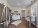 Well-lit kitchen showcasing stainless steel appliances, white cabinetry, and a cozy dining nook at 1686 Terry Mill Se Rd, Atlanta, GA 30316