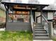 Inviting covered front porch with gray decking, modern railings, and a cozy seating area; perfect for relaxing outdoors at 280 Spellman Nw St, Atlanta, GA 30314