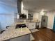 Bright kitchen with stainless steel appliances, granite counters, white cabinets, and dark hardwood floors at 280 Spellman Nw St, Atlanta, GA 30314