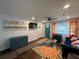 Stylish living room with hardwood floors, colorful rug, bright curtains, and a modern blue cabinet at 280 Spellman Nw St, Atlanta, GA 30314