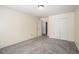 Bedroom with neutral colored walls, carpet, closet and doors to another room at 3423 Conley Downs Dr, Powder Springs, GA 30127