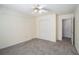 Bedroom featuring neutral carpet and walls, closet and ceiling fan at 3423 Conley Downs Dr, Powder Springs, GA 30127