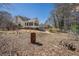 View of the backyard featuring an exterior view of the house's sunroom and trees beyond at 3423 Conley Downs Drive, Powder Springs, GA 30127