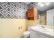 Bathroom featuring diamond accent wall, cabinet storage, and vanity at 3423 Conley Downs Drive, Powder Springs, GA 30127