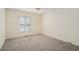 Bedroom featuring neutral walls, plush carpeting, and natural light from one window at 3423 Conley Downs Drive, Powder Springs, GA 30127