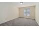 Bedroom featuring neutral walls, plush carpeting, and natural light from one window at 3423 Conley Downs Drive, Powder Springs, GA 30127