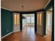 Formal dining room featuring hardwood floors, decorative cabinets, and elegant lighting fixture at 3423 Conley Downs Drive, Powder Springs, GA 30127