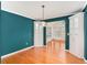 Dining room with hardwood floors, blue walls, built-in cabinets and chandelier at 3423 Conley Downs Drive, Powder Springs, GA 30127