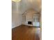 Bright living room showcasing hardwood floors, built-in shelving, and a cozy fireplace with white mantel at 3423 Conley Downs Drive, Powder Springs, GA 30127