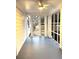 View of screened porch with ceiling fan, white painted rails, and blue painted floor at 5091 Newark Ave, Clarkdale, GA 30111