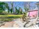 Backyard view of the patio with chairs and a hammock, surrounded by lush greenery at 842 Third St, Stone Mountain, GA 30083