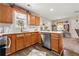 Kitchen with ample counter space, wooden cabinetry, tile backsplash and stainless steel dishwasher at 842 Third St, Stone Mountain, GA 30083