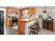 Efficient kitchen featuring tiled backsplash, bar seating, and stainless steel appliances at 842 Third St, Stone Mountain, GA 30083