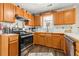 Functional kitchen featuring wooden cabinets, stainless appliances, and great natural light at 842 Third St, Stone Mountain, GA 30083