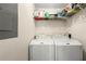 Laundry room featuring a washer and dryer under shelving for storage at 842 Third St, Stone Mountain, GA 30083