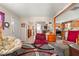 Comfortable living area open to kitchen with neutral carpet, light walls and bright light at 842 Third St, Stone Mountain, GA 30083