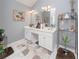Bathroom featuring a double vanity, large mirror, and decor at 1009 S Creek Dr, Villa Rica, GA 30180