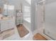 Bright bathroom featuring a glass shower, soaking tub, and vanity with marble floors at 1009 S Creek Dr, Villa Rica, GA 30180