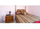 Charming bedroom with a four-poster bed, soft pink walls, and bedside table at 1009 S Creek Dr, Villa Rica, GA 30180