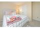 Bright bedroom features a queen bed with stylish bedding, soft carpet, and a closet at 1009 S Creek Dr, Villa Rica, GA 30180