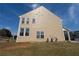 Side view of a two-story house with a large yard and several windows under a blue sky at 1009 S Creek Dr, Villa Rica, GA 30180