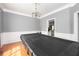 Spacious game room with a pool table, decorative molding and a hanging chandelier at 1009 S Creek Dr, Villa Rica, GA 30180