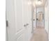 Hallway with doors and access to rooms, neutral carpet, and overhead lighting at 1009 S Creek Dr, Villa Rica, GA 30180