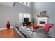 Bright living room featuring hardwood floors, fireplace, comfortable sofa, and stylish decor at 1009 S Creek Dr, Villa Rica, GA 30180
