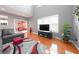 Bright living room featuring hardwood floors, fireplace, comfortable sofa, and stylish decor at 1009 S Creek Dr, Villa Rica, GA 30180