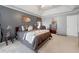 Comfortable primary bedroom with king bed, accent wall, and cozy sitting chair at 1009 S Creek Dr, Villa Rica, GA 30180