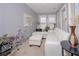 Sitting room with natural light, white sofa and ottoman, and plants at 1009 S Creek Dr, Villa Rica, GA 30180