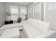 Bright sitting area with natural light streaming through large windows, with white furniture and decor at 1009 S Creek Dr, Villa Rica, GA 30180