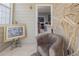 Cozy sunroom featuring large windows, a comfortable chair, and a view of the indoors at 1009 S Creek Dr, Villa Rica, GA 30180