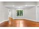 Living room with hardwood floors, white trim and a view of the trees through the window at 159 Forest Ave, Social Circle, GA 30025