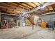 Unfinished basement showing exposed pipes and ceiling, concrete flooring and wooden stairs at 3798 Valley Brook Rd, Snellville, GA 30039