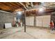 Spacious unfinished basement with concrete flooring and two garage doors at 3798 Valley Brook Rd, Snellville, GA 30039