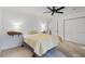 Bright bedroom with carpet, ceiling fan, and closet, lit by bedside lamps on floating shelves at 3798 Valley Brook Rd, Snellville, GA 30039