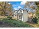 Charming two-story home with balconies, complemented by lush greenery and wooden fence at 3798 Valley Brook Rd, Snellville, GA 30039