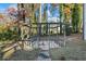 Enclosed gazebo with stone tile and wood frame for backyard shade at 3798 Valley Brook Rd, Snellville, GA 30039