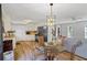 Bright kitchen dining area featuring black appliances, stylish chandelier, and hardwood floors at 3798 Valley Brook Rd, Snellville, GA 30039
