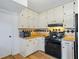 Well-maintained kitchen featuring white cabinets, black appliances, and hardwood floors at 3798 Valley Brook Rd, Snellville, GA 30039
