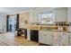 Bright kitchen area with white cabinets, stainless steel sink, and sliding glass door to deck at 3798 Valley Brook Rd, Snellville, GA 30039