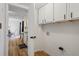 Bright laundry room with white cabinets and hardwood floors, offering practicality and a clean aesthetic at 3798 Valley Brook Rd, Snellville, GA 30039