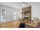 Bright living room with stone fireplace, hardwood floors, and neutral decor at 3798 Valley Brook Rd, Snellville, GA 30039