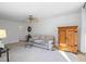 Cozy living room featuring a ceiling fan, a comfortable sofa, and a classic wooden cabinet for storage at 3798 Valley Brook Rd, Snellville, GA 30039