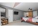 Comfortable main bedroom featuring a ceiling fan, a wall-mounted TV, and a sliding barn door at 3798 Valley Brook Rd, Snellville, GA 30039